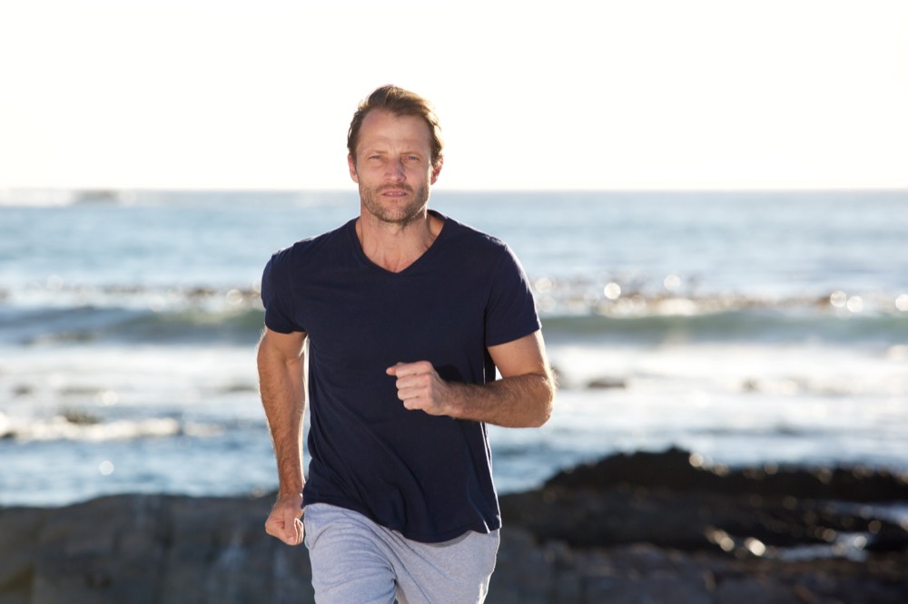 A man running along the coast