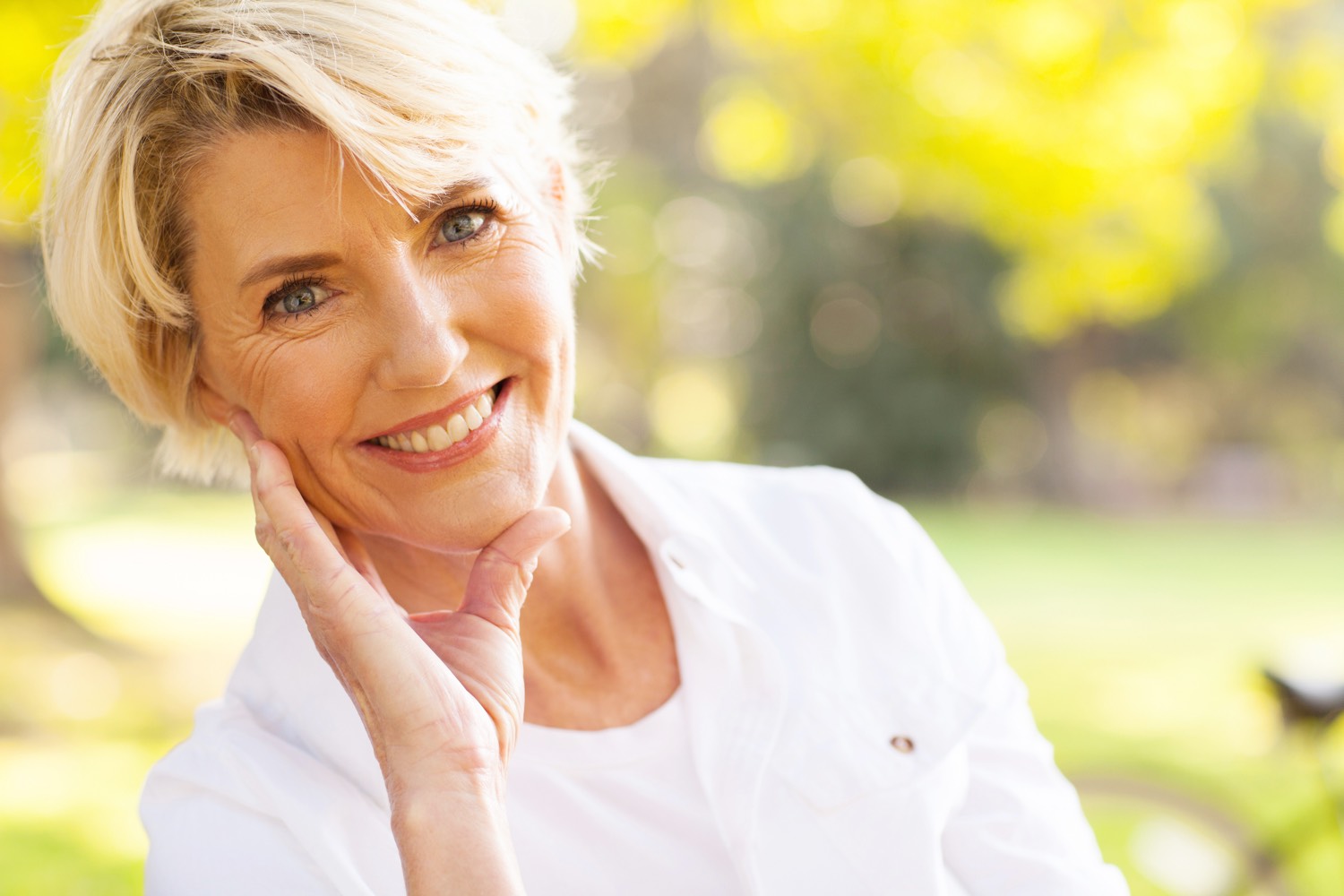 A woman aging confidently, outdoors in natural light